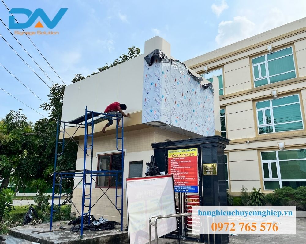Thợ đang thi công bảng hiệu quảng cáo Lai Uyên